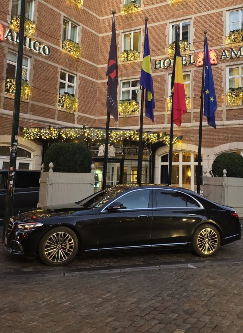 Luxury chauffeur vehicle parked outside a premium hotel in Brussels